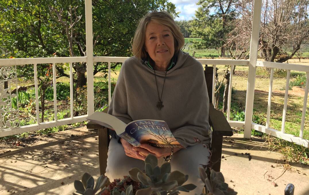 Jane Carter in the gazebo of her country garden near Narrandera reading an excerpt from her latest novel 'Prodigal Daughter'.