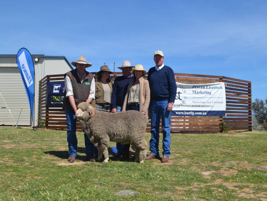 General manager Cavan Station, Yass Matt Crozier with Danish visitor Emelie Lynggaard, John and Anna Hyles, Tharwa and auctioneer Paul Dooley, Tamworth with the top priced ram bought by the Hyles for their Merino flock.