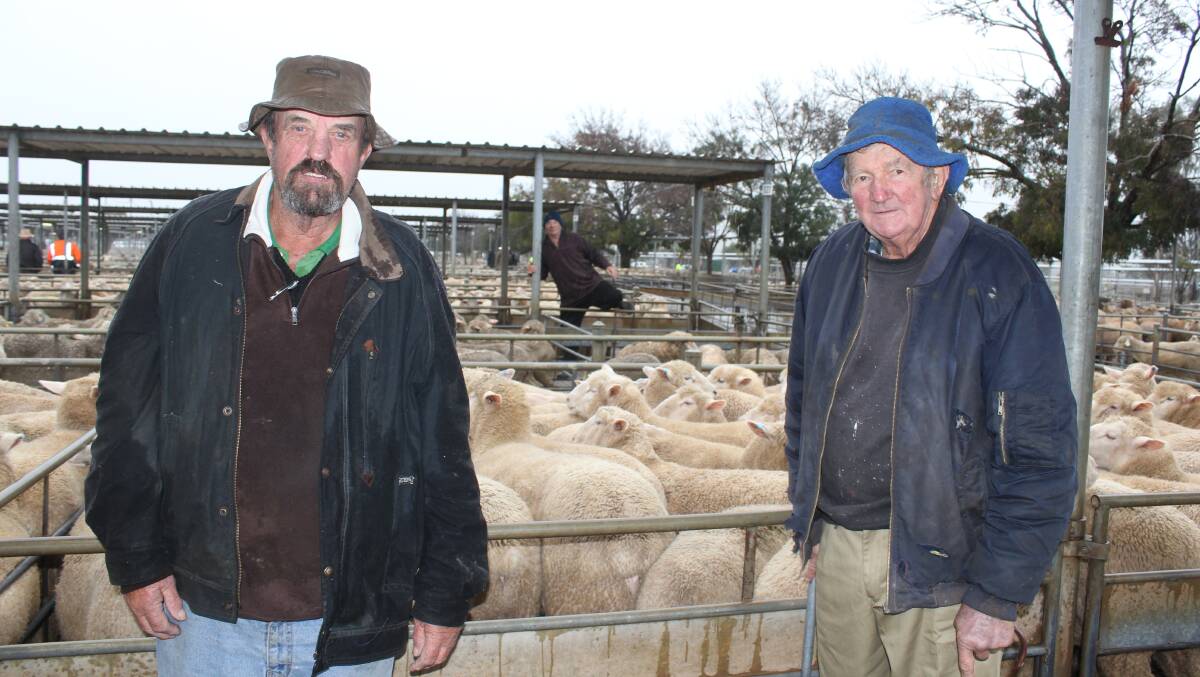 BLITZING THE FIELD: George Wilson of RH Blake is pictured with vendor Gordon Rodham of "Cranbrook", Uranquinty. Mr Rodham sold lambs for $228. Picture: Nikki Reynolds
