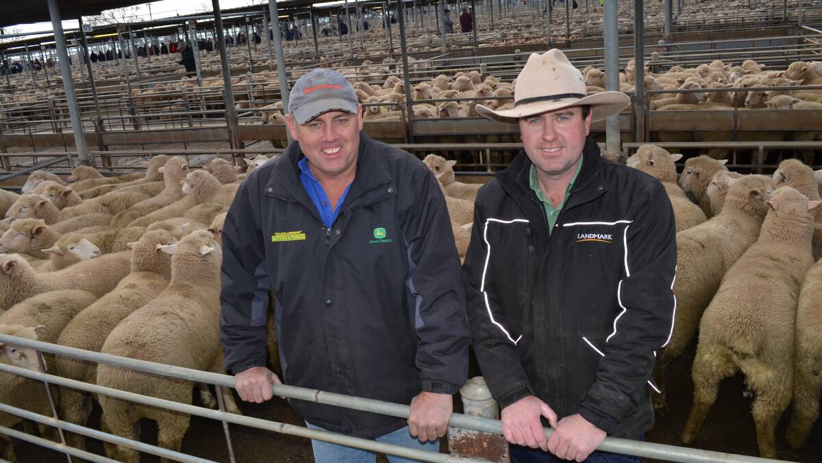 PRODUCER John White (left) sold sucker lambs for $196.20 at Wagga. He is pictured with Jarrod Slattery of Landmark Wagga.