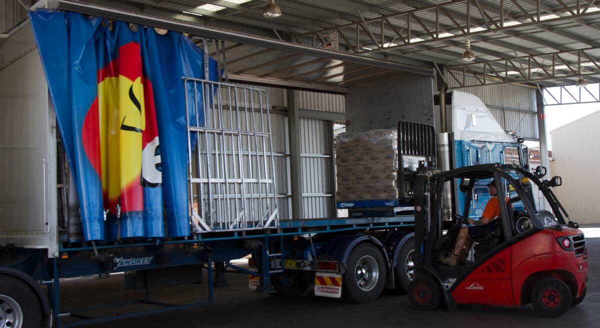 HELPING HAND: SunRice warehouse operator David Bush loads the SunRice produce onto the truck ready for delivery on Tuesday morning. Photo: Talia Pattison 
