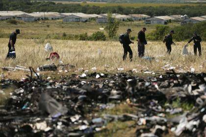 Australian Federal Police and their dutch counterparts searching at the MH17 crash site. Photo: Kate Geraghty