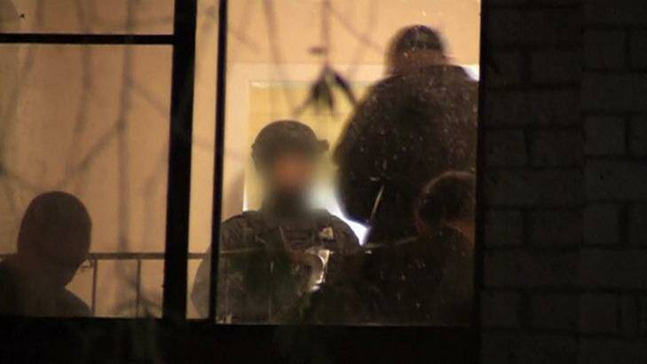 Police are seen inside a house during a raid in Sydney, in this still image taken from a police handout video on September 18, 2014.  Photo: Reuters TV
