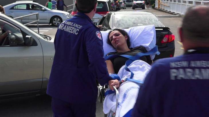 A woman receives treatment after the Bankstown shooting. Photo: a