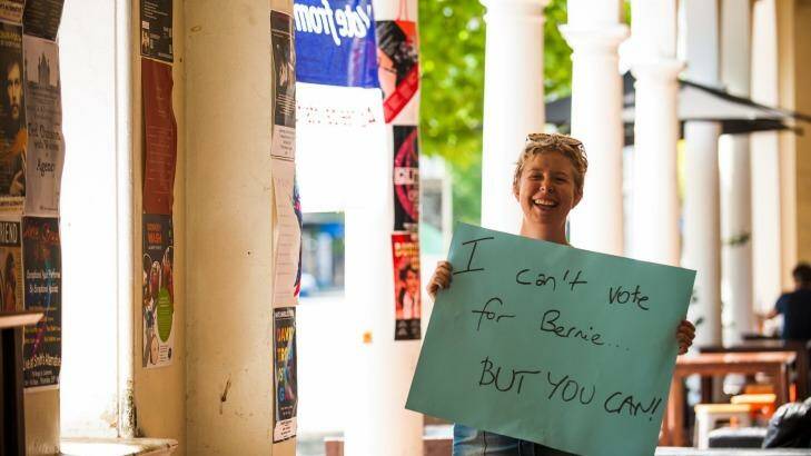 Emilie Carey of Hackett encourages American Democratic Party members living in Australia to cast their vote for the presidential primaries at Smiths Alternative bookshop. Photo: Elesa Kurtz