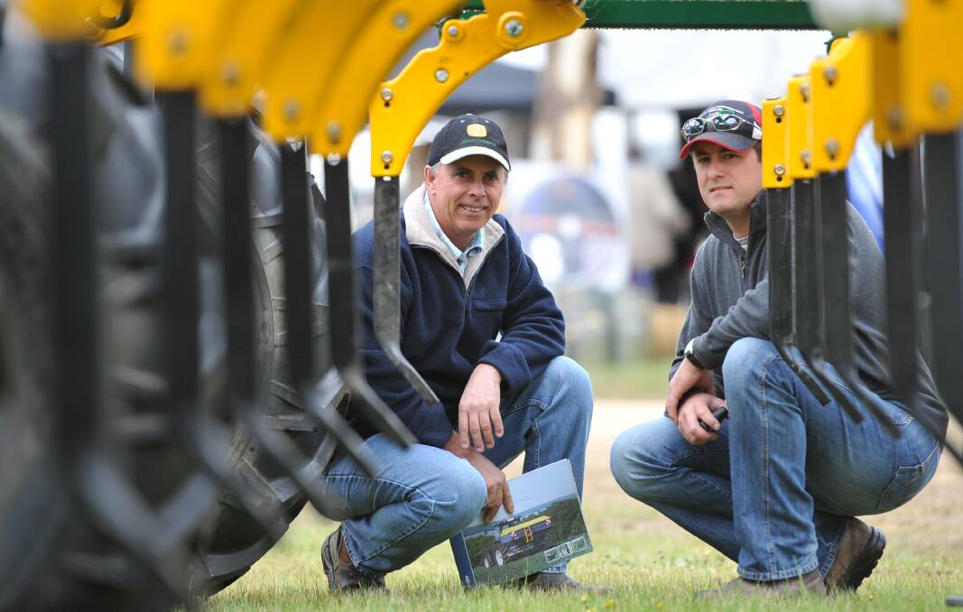 Father and son, Ian Singleton and Ian Singleton (jnr) from Jerilderie inspect the displays at the Henty Machinery Field Days. Picture: Michael Frogley
