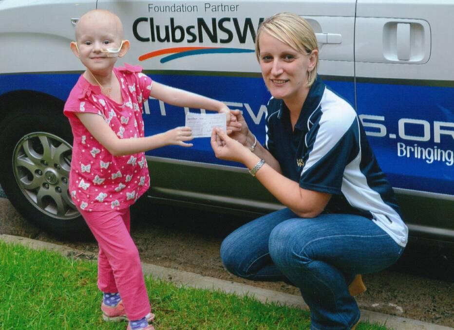 Isabella McInerney, 4, from Coolamon presents a cheque to Mel Grand from Little Wings.