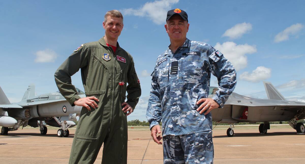 TOUCH DOWN: United States Air Force 90th Fighter Squadron Commander Lieutenant Colonel David Skalicky and Senior Australian Defence Officer RAAF Tindal, Wing Commander Andrew Tatnell. A F/A-18 Hornet, based at Tindal RAAF Base near Katherine, is on the left and US F-22 Raptor is on the right.