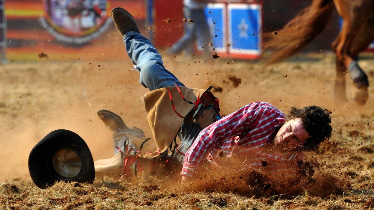 COOLAMON RODEO: Matt Sheather hits the dirt in the second division bronc ride. Picture: Addison Hamilton