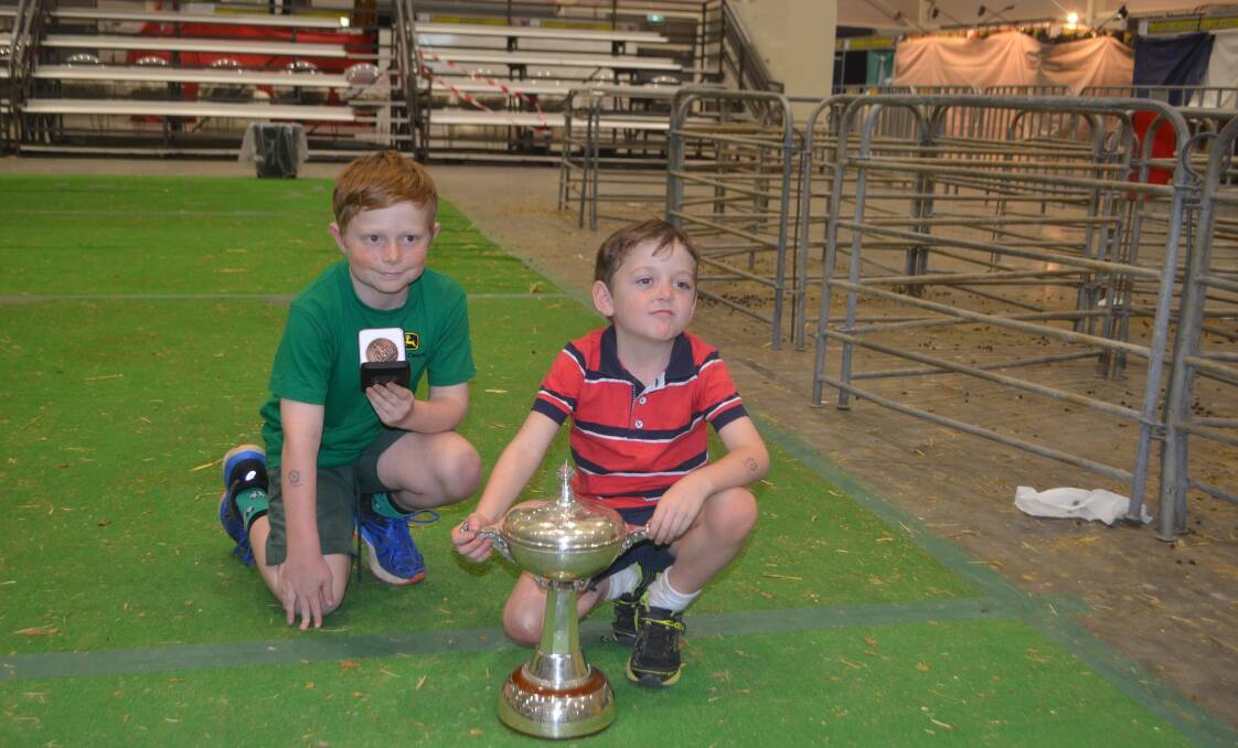 Toby and Hugh Corkhill, Grassy Creek stud, Reids Flat with the medallion for grand champion finewool Poll Merino ewe and the Otway Falkiner Trophy for group of five Poll Merino sheep.