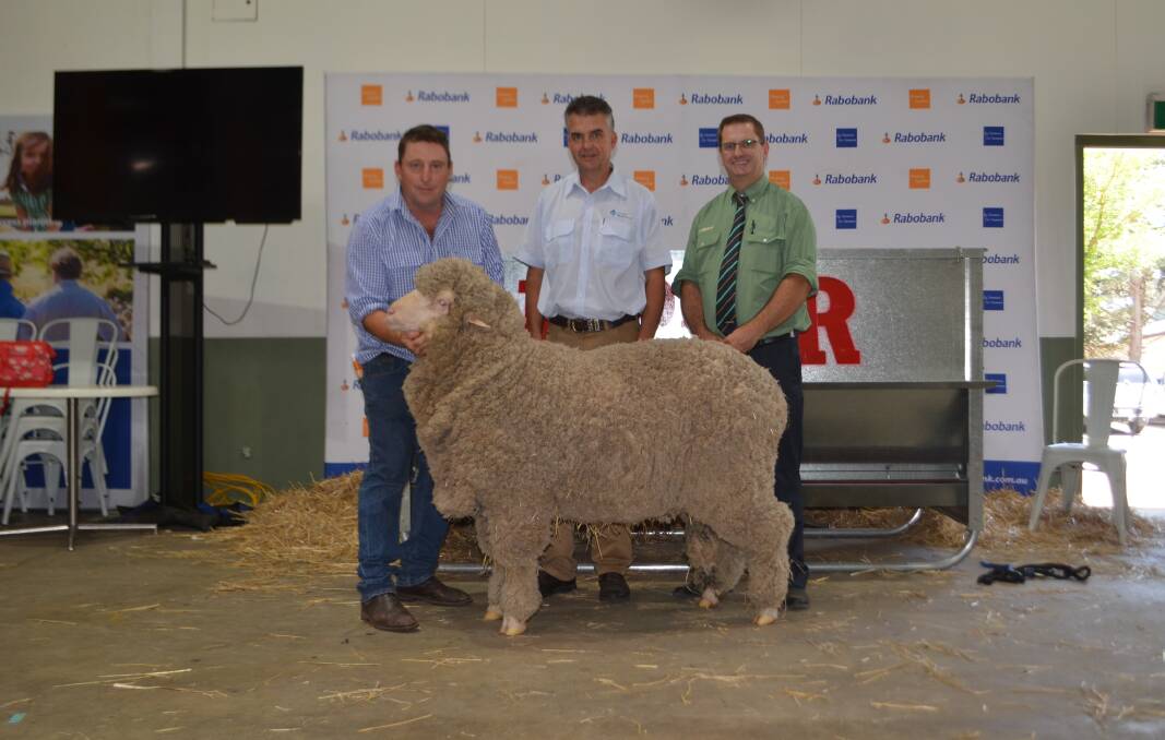 Michael Corkhill, Grassy Creek, Reids Flat with his ram purchased by Mark Hedley, AWN state manager on behalf of Tom Johnson, Johnson Park Merinos, Bookham for $5000 and Landmark auctioneer Rick Power.

