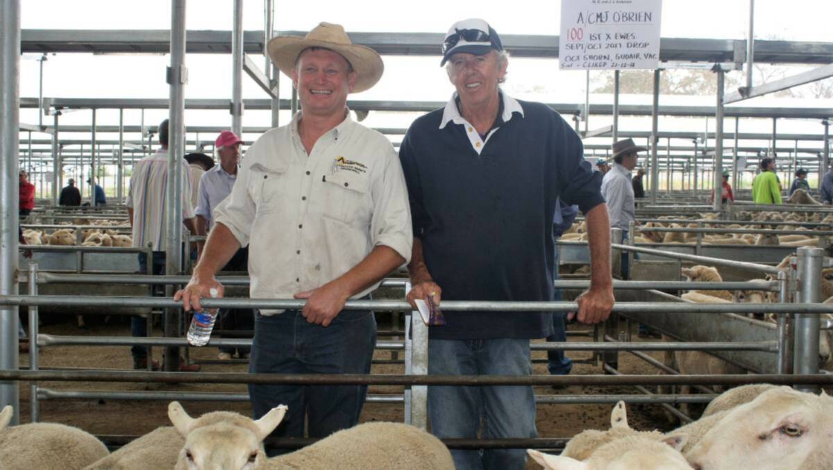 Greg Anderson (left), M. D and J. J Anderson, Crookwell got the second top price at $274 for the 251 one and half-year ewes  offered by John O’Brien (right) from Boobalaga, Crookwell. Photo: Hannah Sparks
