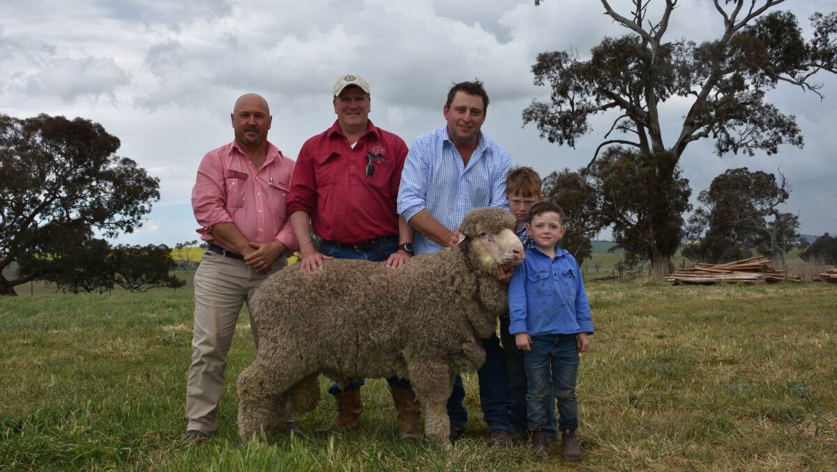 Craig Pearsall, Elders Goulburn; buyer Tom Gunthorpe, "Mt Buffalo", Yass; with Michael Corkhill holding the second top price ram, with sons Toby and Hughie. 