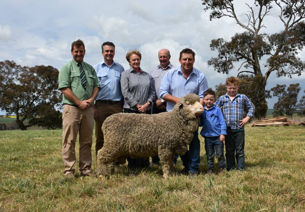 Landmark auctioneer Rick Power, Boorowa; Australian Wool Network NSW state manager Mark Hedley; purchasers Trish and Gary Hallam, Gunning; with their top price ram held up Grassy Creek owner Michael Corkhill and sons Hughie and Toby. 