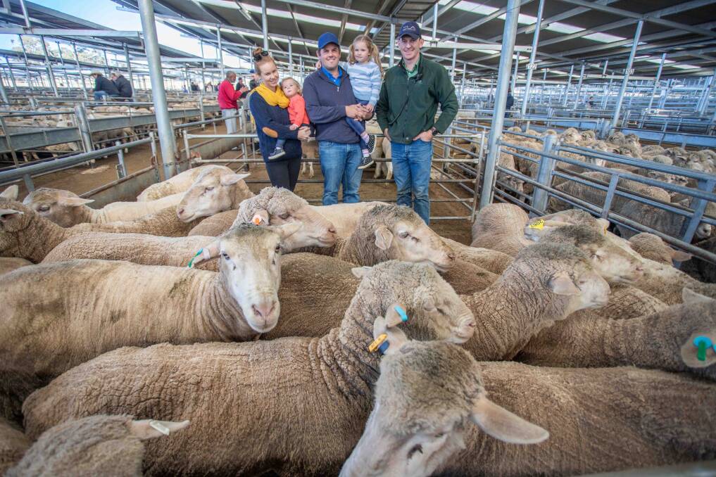 MEET THE MARKET: Steph and Alex Willson with daughters Sophie and Lara Karalee Poll Merinos, Crookwell with Matt Joseph, Landmark. Their pen of 18 Merino ewes sold for $194. Picture: Supplied