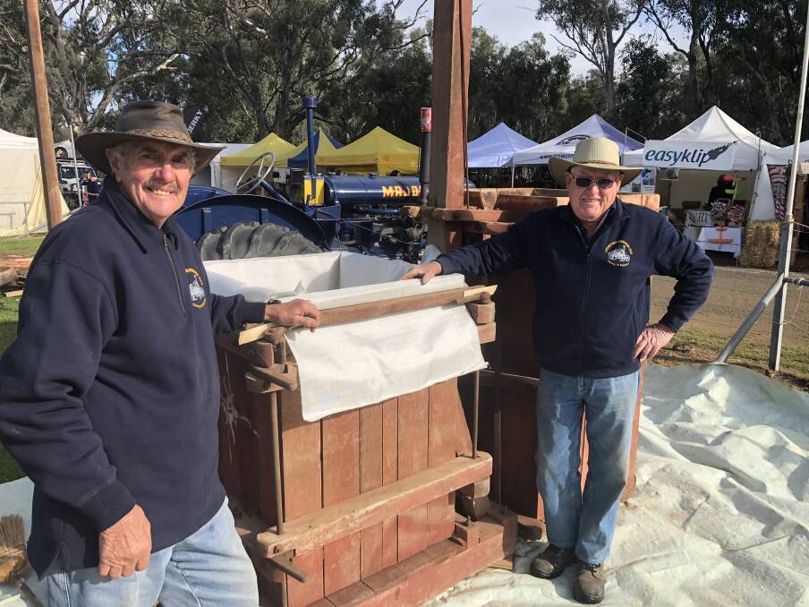RARE FIND: Kerry Pietsch of Pleasant Hills and John Kingston of The Rock are pictured with a wool press from the 1930s. Picture: Nikki Reynolds