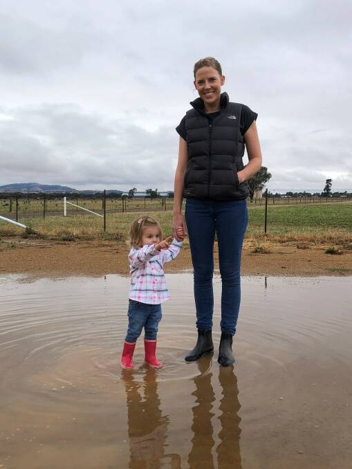 GUMBOOT DAY: Martha Yates, 2, of Yerong Creek is pictured with her mum Jemma after 38mm of rain fell in the region overnight. 