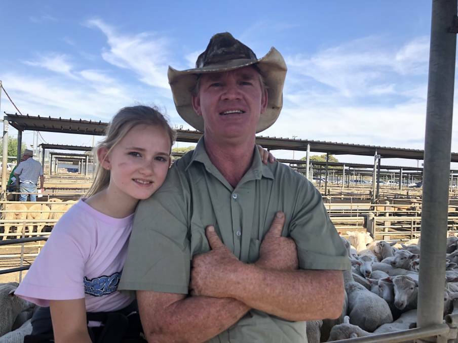 LAMB MARKET: Elvara Drum, 9, and her dad David Drum of Marrar are pictured at the sheep and lamb sale in Wagga. Picture: Nikki Reynolds