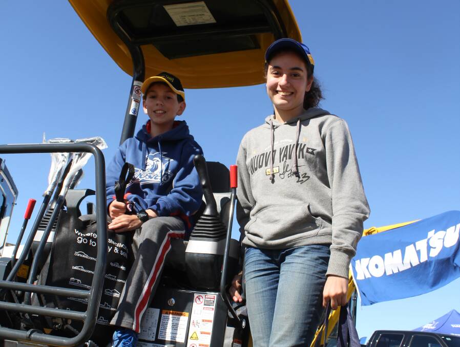 KICKING THE TYRES: Anthony Pace, 10, and his sister Christina, 14 of Marulan inspect a Komatsu digger at the Henty Machinery Field Days. Pictures: Nikki Reynolds