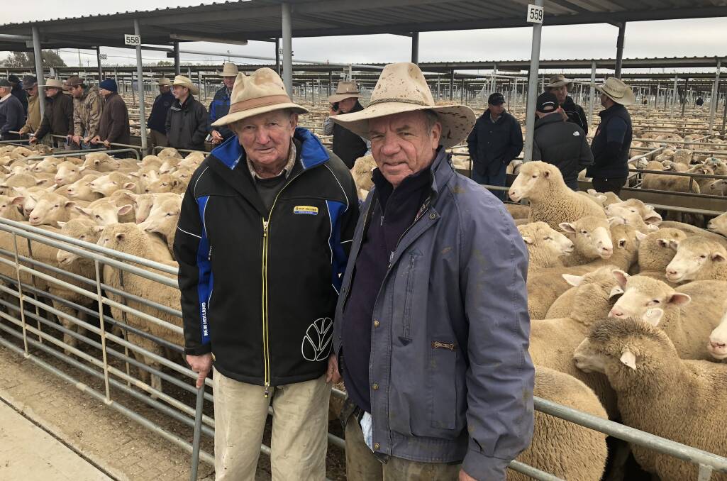 NEW RECORD: Vendor Gordon Rodham, with livestock agent Mark Logan, last broke a new-season lamb record in 2018 at the Wagga Livestock Marketing Centre. Picture: Nikki Reynolds