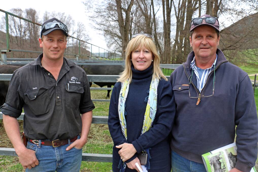 BULL OFFERING: Reiland's Sam Lucas, with Lucy and Simon Locke, Book Book, inspecting bulls at the spring sale. The Lockes bought two bulls to a top of $8000. Picture: Supplied