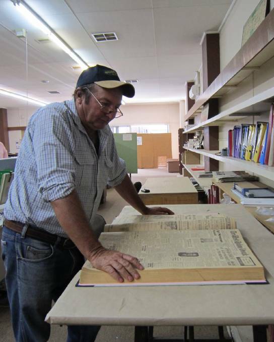 THOROUGH RESEARCH: Old newspapers provide a valuable insight into years gone by for Ross Harmer. Picture: West Wyalong Advocate