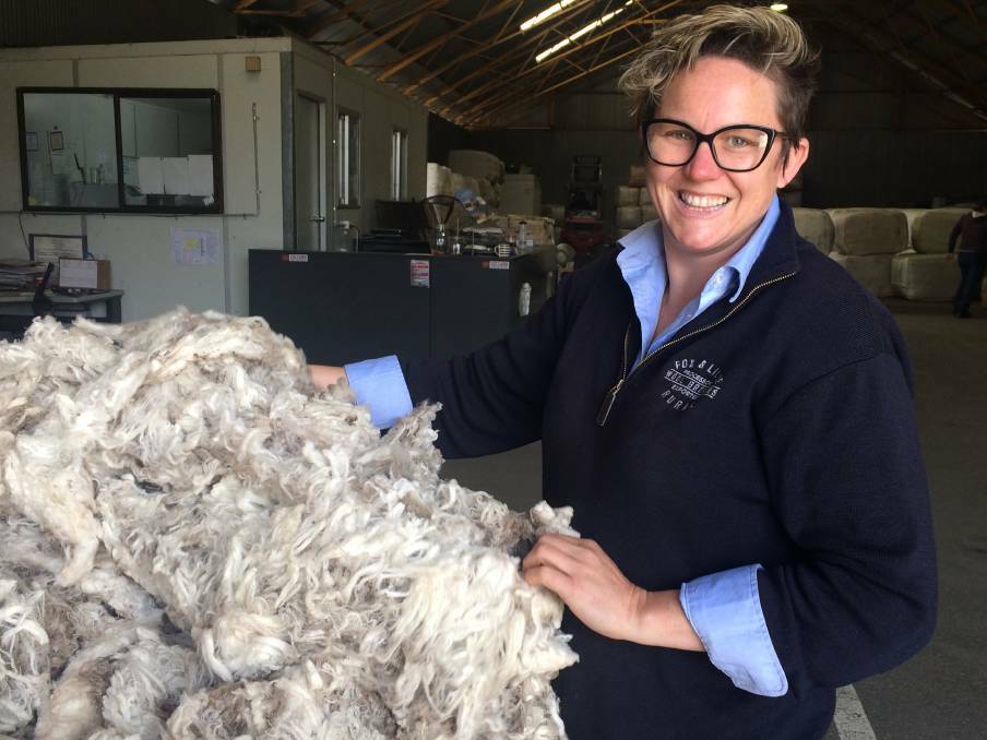 OPTIMISM: Jenni Turner of Fox and Lillie at Culcairn in southern NSW inspects a fleece. She welcomes the increase in prices for wool in recent times. Picture: Nikki Reynolds
