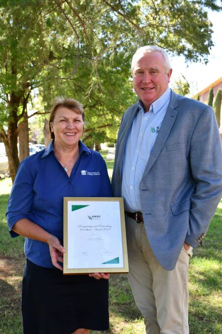 RECOGNITION: GRDC Northern Region Panel chairman John Minogue presenting the 2019 Recognising and Rewarding Excellence award to NSW DPI Wagga Agricultural Institute director Deb Slinger. Picture: GRDC