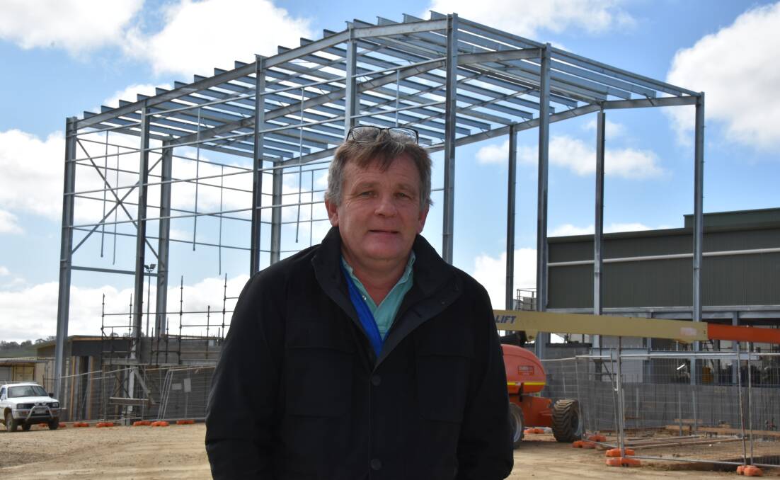 The Junee abattoir is in expansion mode, with three automated chillers due to come on line in about three weeks. Here owner Heath Newton stands in front of a new cold store currently being constructed.