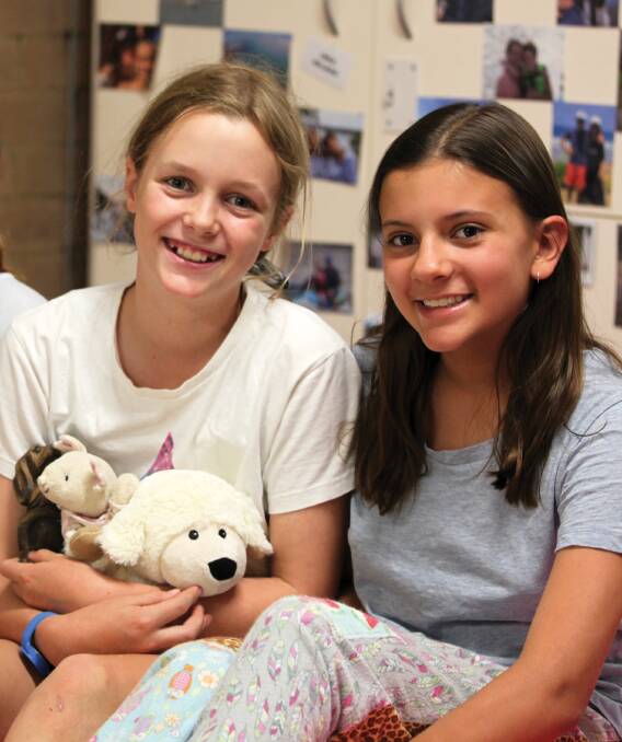 YEAR 7 students Lucy Arnott (Coolah, left) and Matilda Damiani (Red Hill) relax before bedtime in the newly refurbished Kennedy House.