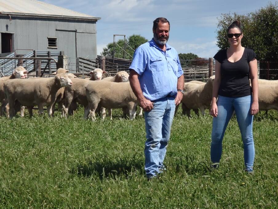 NORM Crawford with daughter Jazmyn and a group of old and new Kentish Downs Poll Dorset Rams.