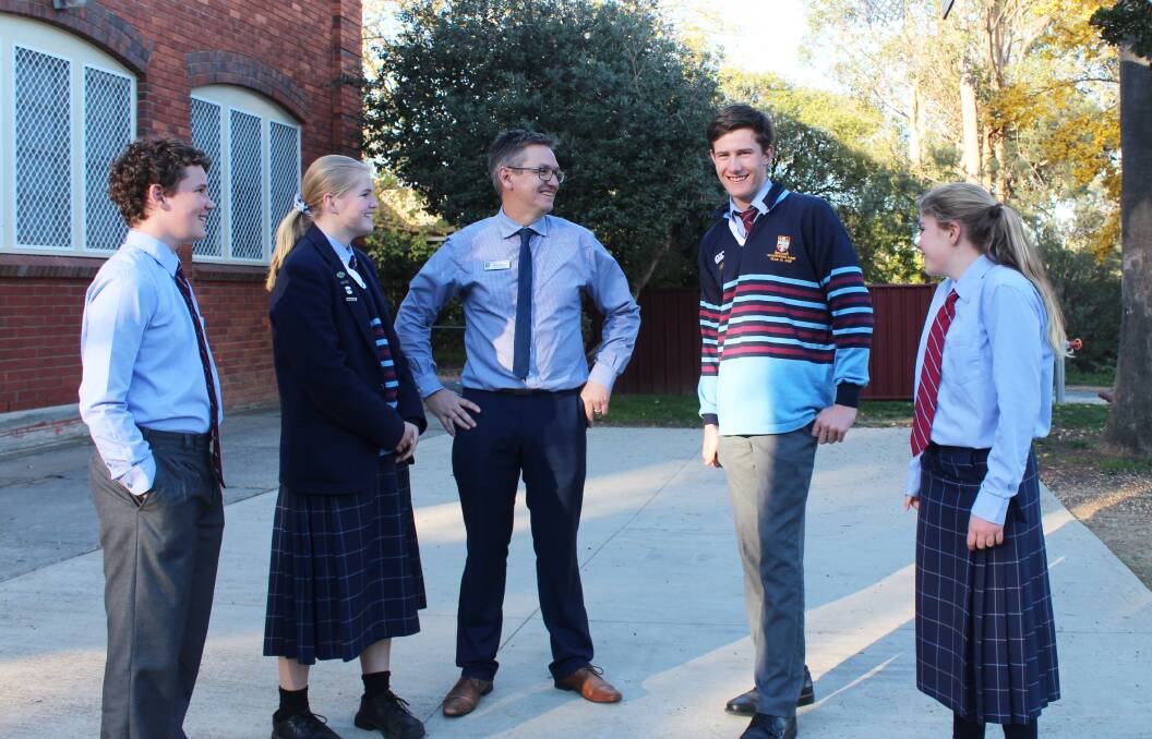 COME TOGETHER: Scots year 7 and year 12 boarders chatting with director of boarding Neale Poole.