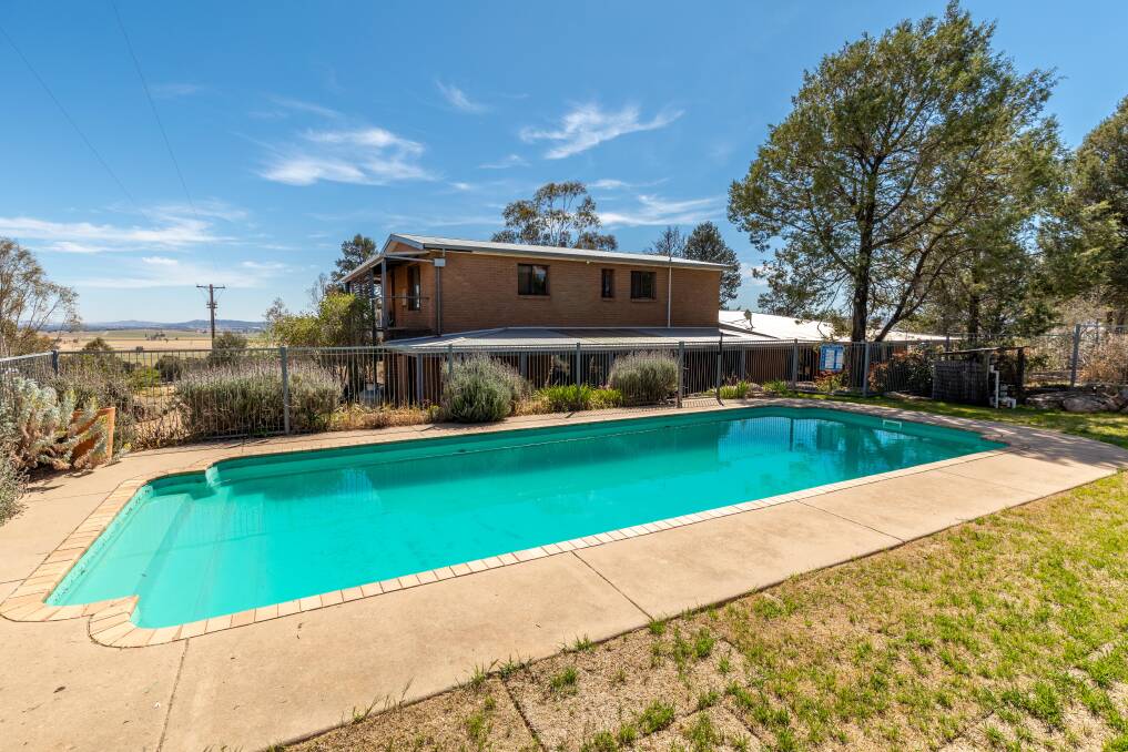 DELIGHTFUL: The home boasts six bedrooms and multiple living spaces, set amongst native plantings and with an inground pool.