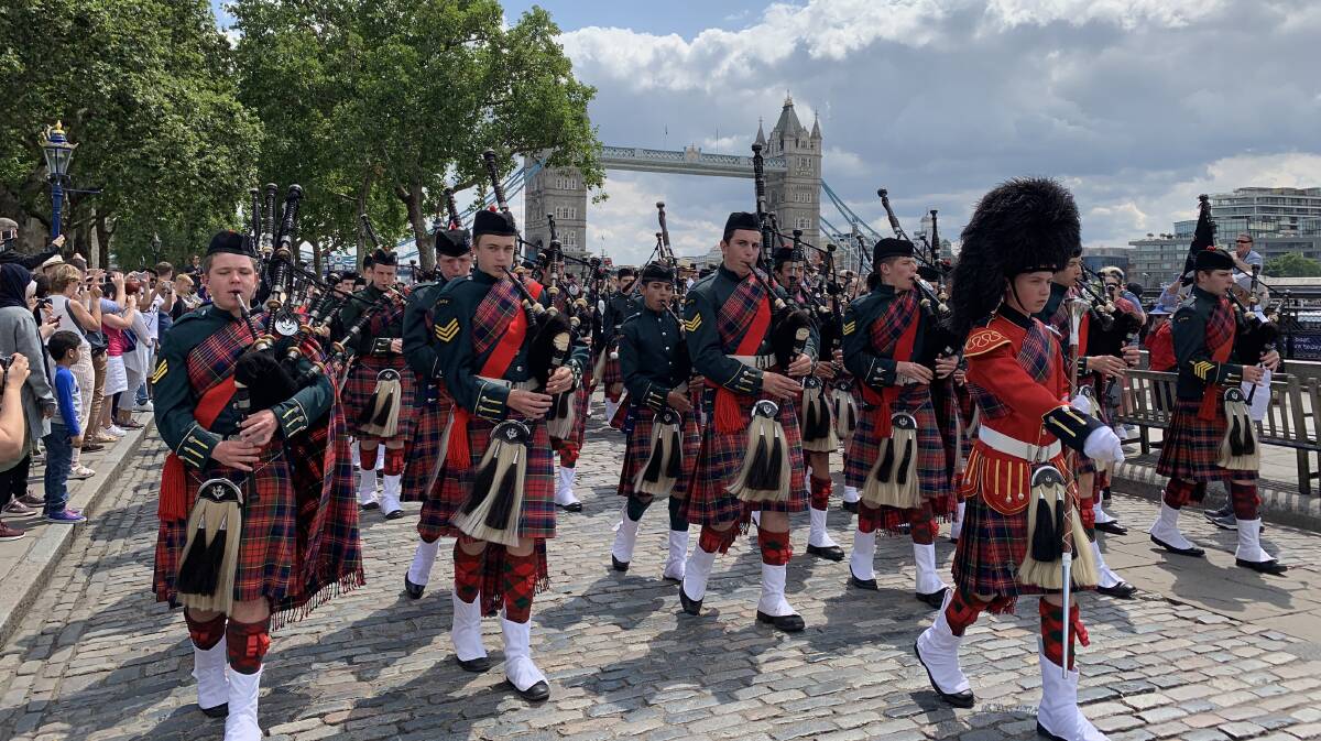 ON TOUR: The Knox Pipes & Drums performing at the Tower of London, alongside the River Thames with Tower Bridge in the background.