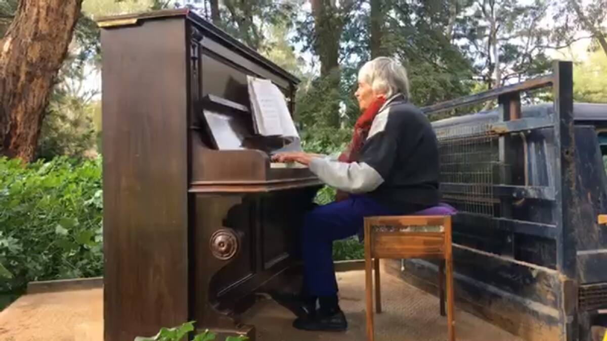 PLAYER: Resident pianist, Cath Russ, belts out a tune while on the back of a ute for Warren Church Online. 