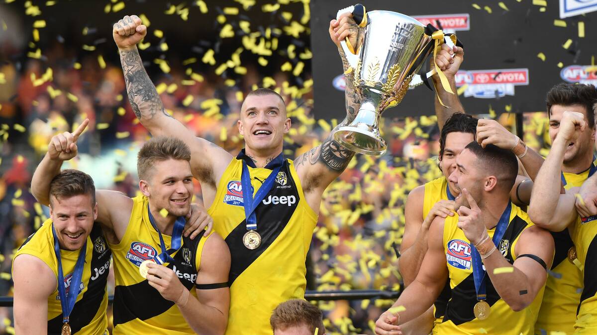 Dustin Martin holds aloft the AFL premiership cup on Saturday. Picture: AAP