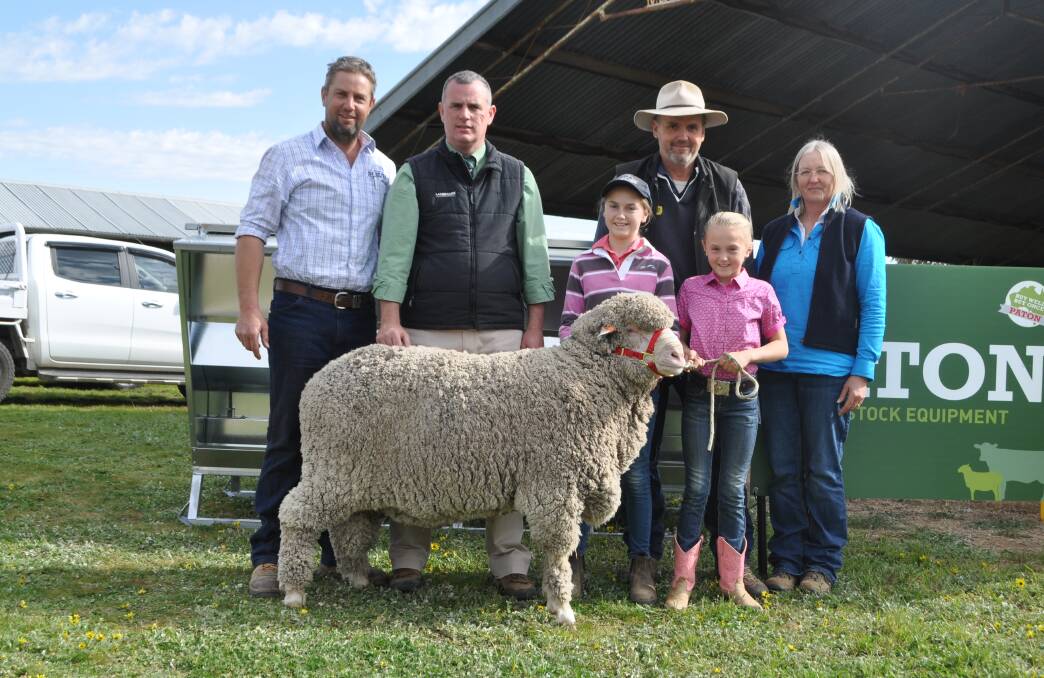 The top priced ram from Meadow View Poll Merino, Henty with Simon Bahr, Meadow View, Peter Godbolt, Landmark, Evie and Layla Bahr, Meadow View and purchasers Joanne and Peter Rayner, Alma Park. 