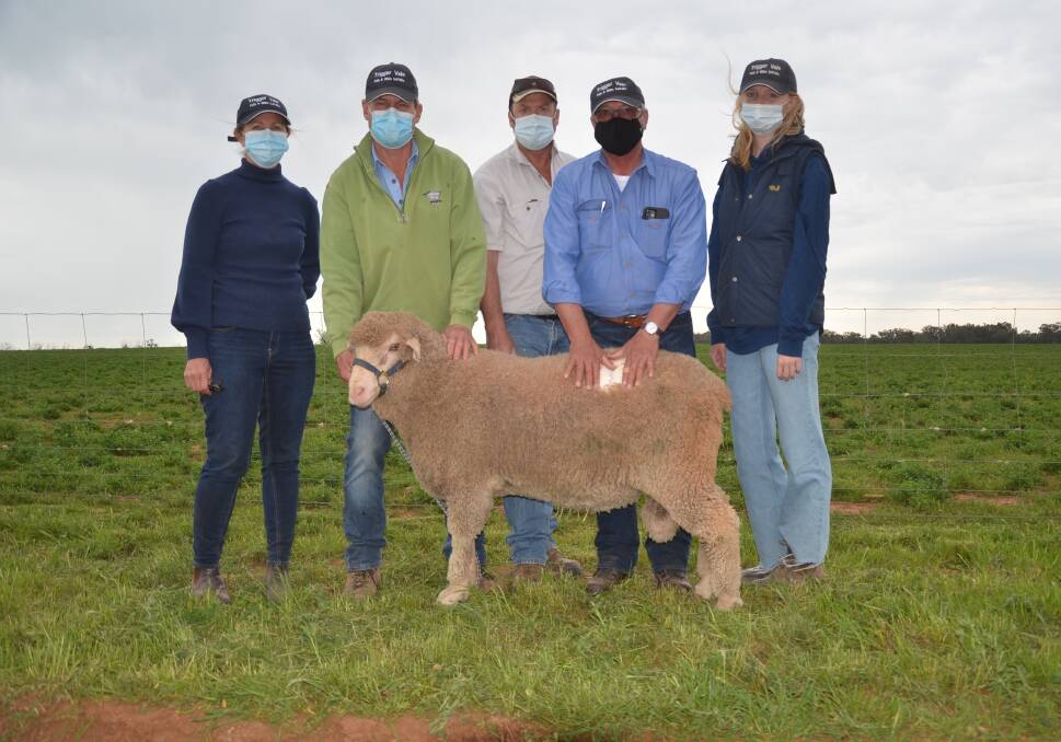 The top-priced ram with Trigger Vale's Mandi, Andrew and Ruby (right) Bouffler, purchaser Phil Edwards, Pindari Bond Stud, Yerong Creek, and Trigger Vale classer Michael Elmes. 
