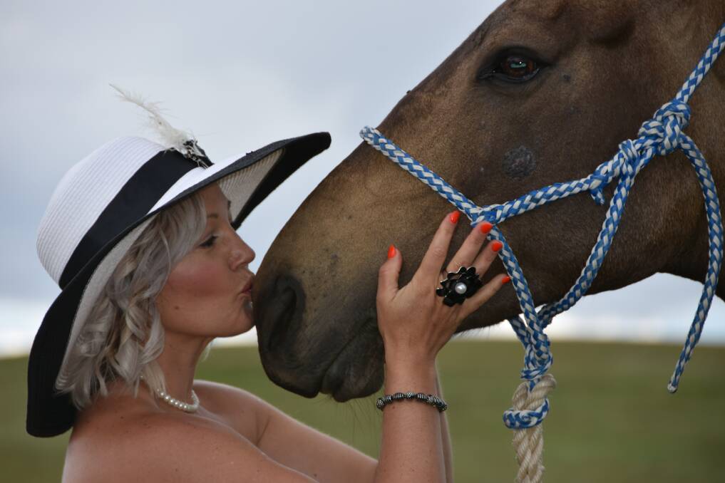 Joanne Mayhew gives her horse Martha, a clerk of the course horse, a kiss not for a job well done, but for being patient, after Adaminaby races were called off before a race was run due to a thunderstorm that left the track slippery.