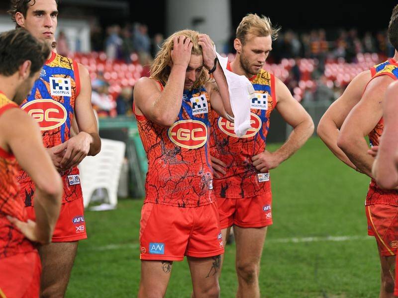 Gold Coast players react following the Round 17 AFL thrashing by Adelaide on Saturday.