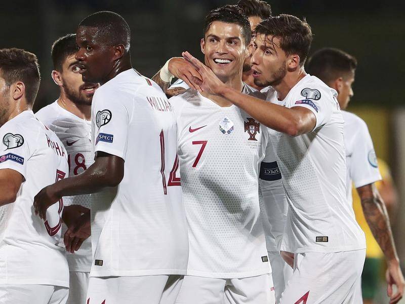 Portugal's Cristiano Ronaldo (2R) celebrates one of his four goals with teammates against Lithuania.