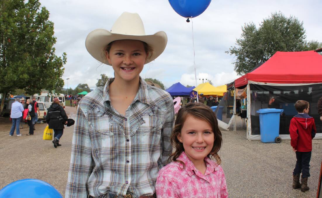 Sally Moore, 13, from Borambola and Molly Harper, 6, from Wagga soak up the atmosphere at the Man From Snowy River Festival at Corryong. Pictures: Nikki Reynolds