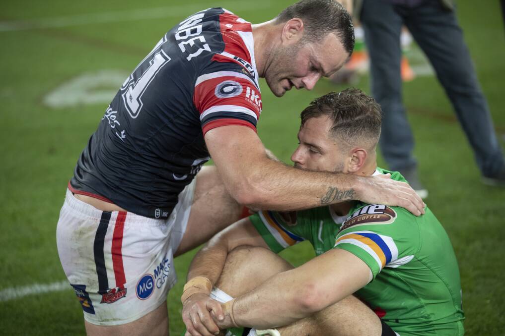 Roosters captain Boyd Cordner consoles Raider Aiden Sezer. Picture: Sitthixay Ditthavong