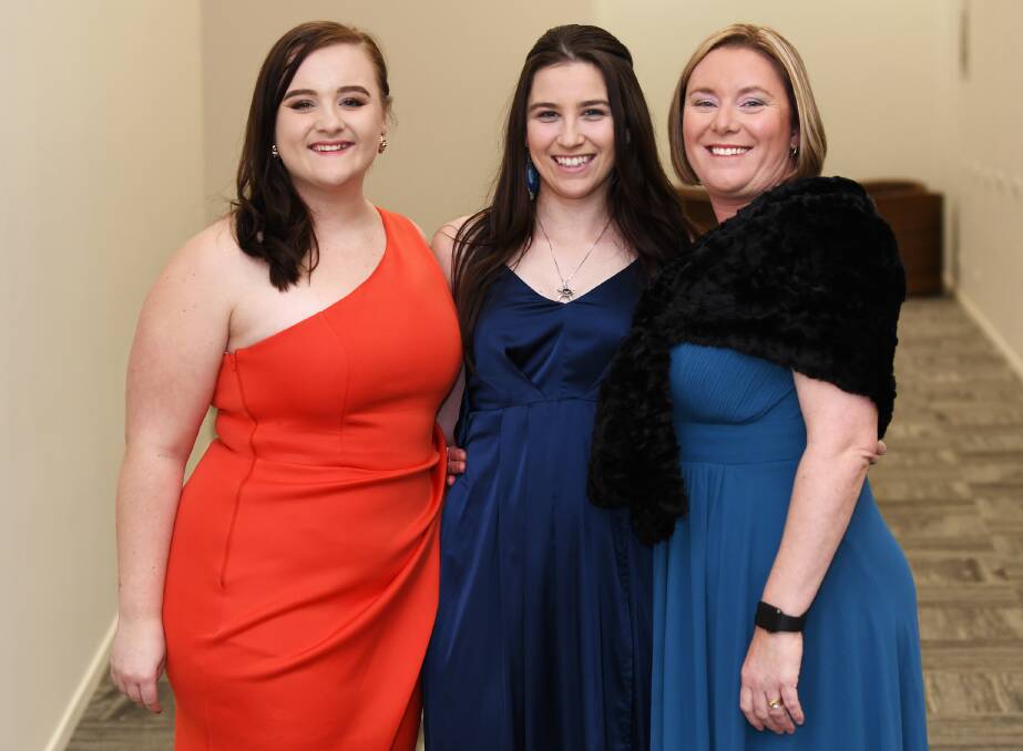 LADIES NIGHT: Kellie McMurtie, Taren Gleeson and Natasha Small go for colour and class at the Rural Ball.