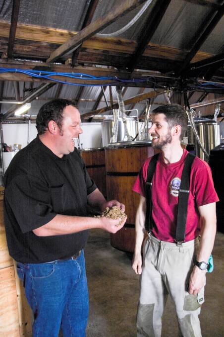 Dale Goodwin with New England Brewing Co head brewer Reid Stratton and some of the spent grain which Mr Goodwin collects daily. 