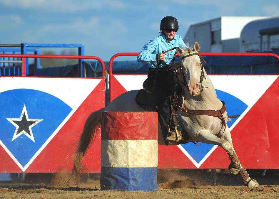 Laine Seary from Junee participates in the barrel race at the 2013 Wagga Rodeo.